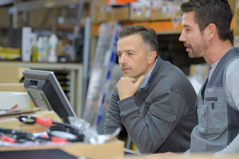 Manager and employee using convenience store distribution software