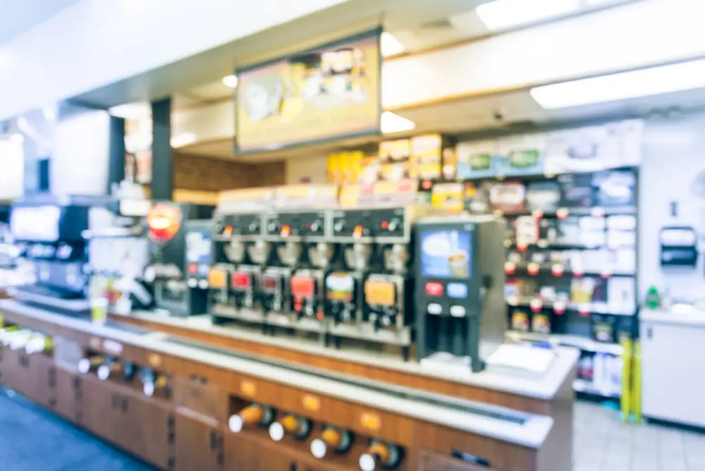 blurred image of convenience store coffee and beverage equipment