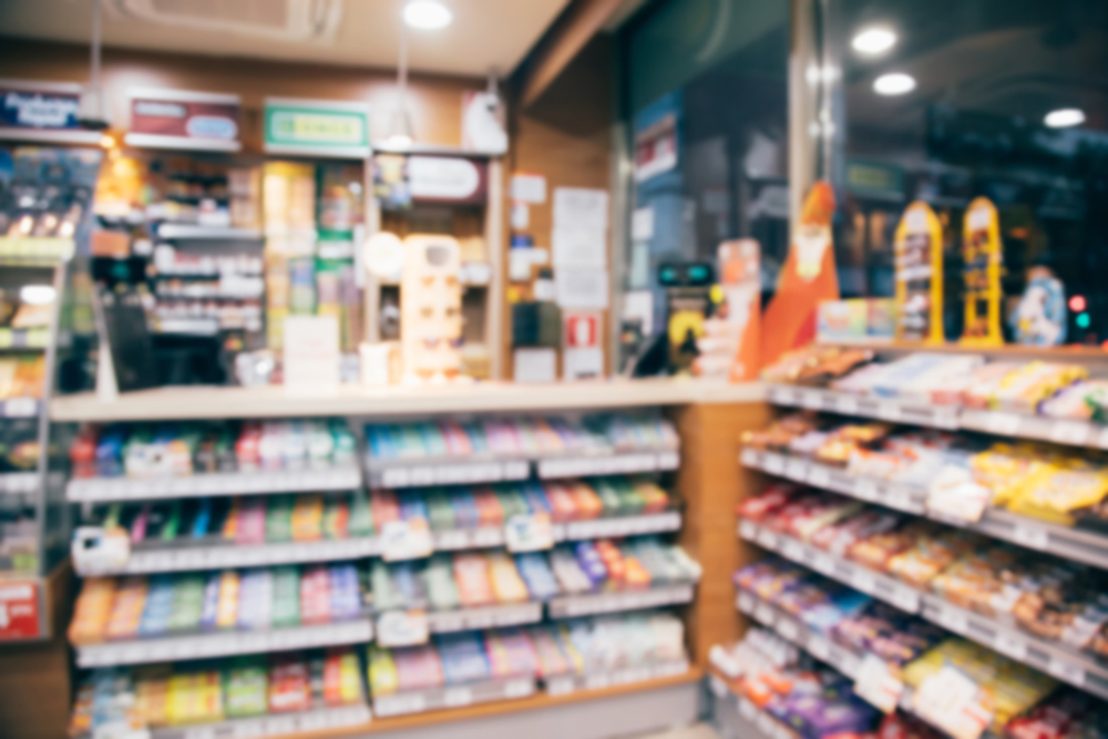 blurred image of convenience store counter with candy and other products