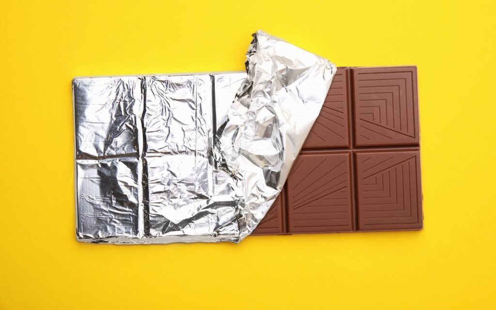 chocolate bar with foil partly unwrapped