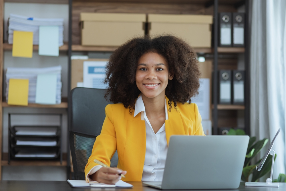 woman in financial management sitting at laptop in office