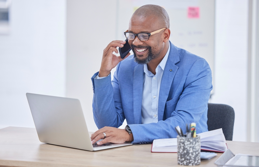 african american male professional smiling on vendor relationship phone call