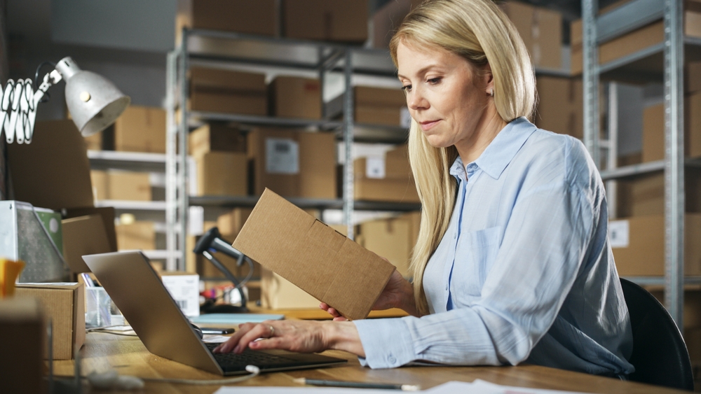 female warehouse manager using distribution software