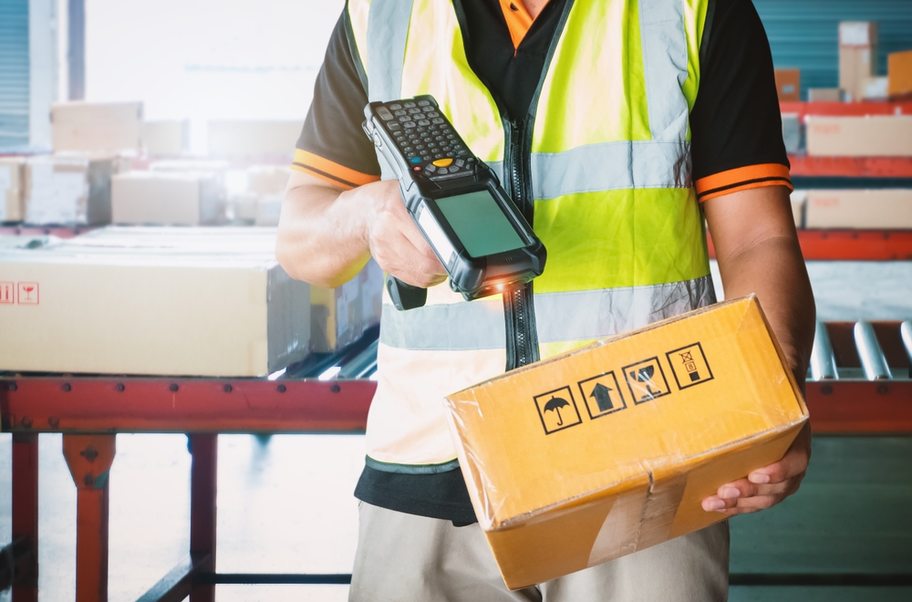 warehouse worker scanning box with mobile ERP solution scanner