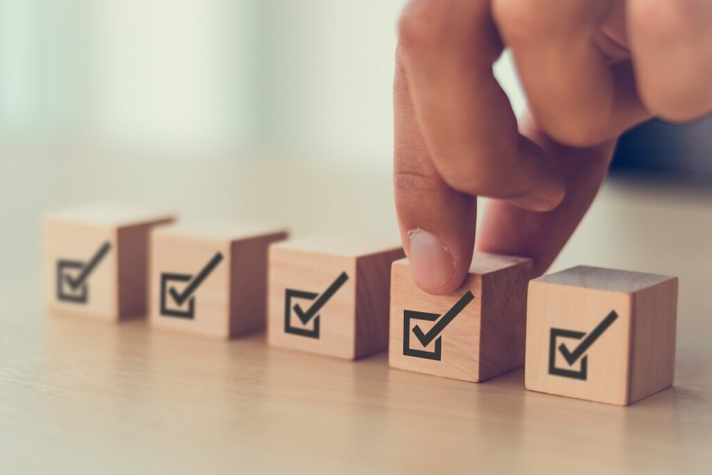 hand placing erp regulatory compliance checkboxes in a row