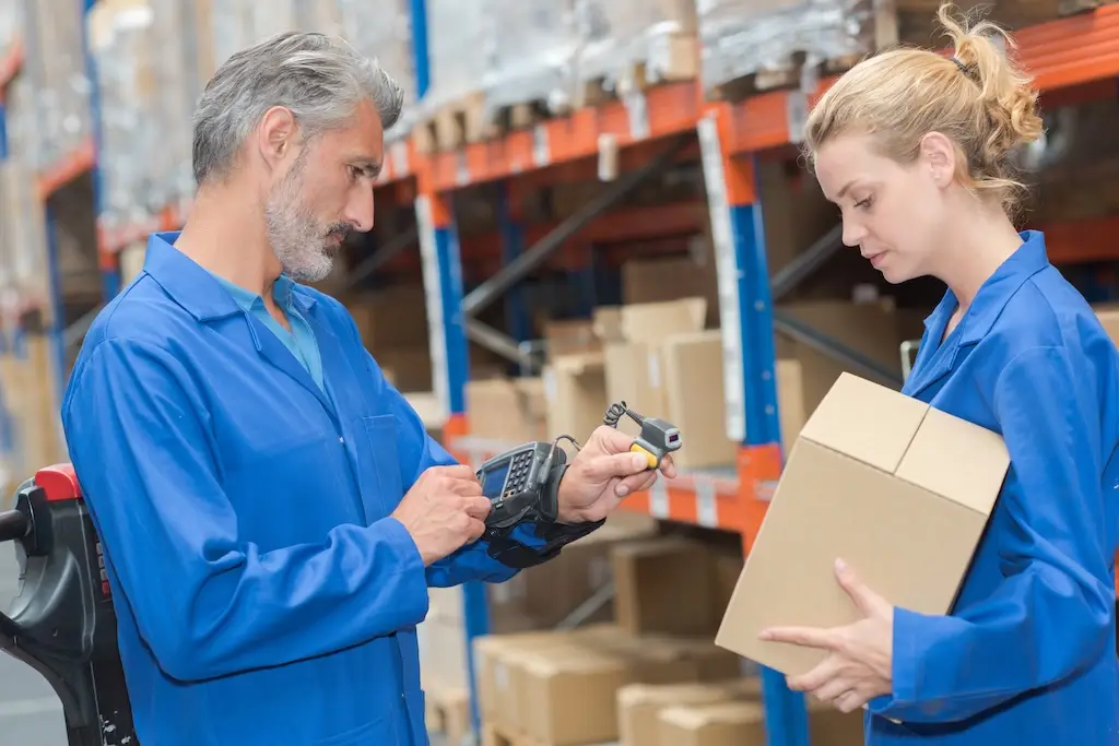 male and female warehouse workers using wrist-mounted picking system