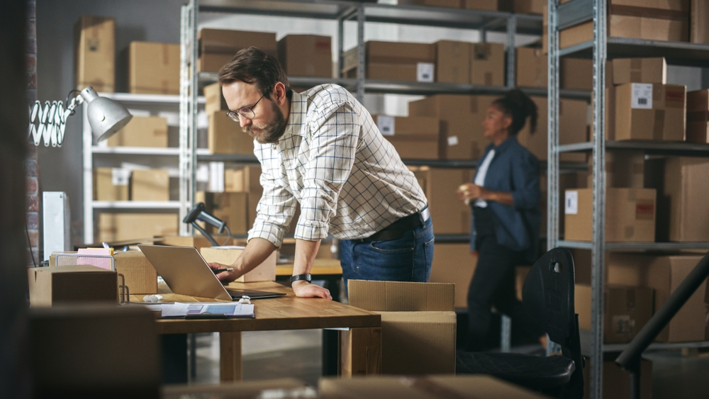 manager using distribution erp software