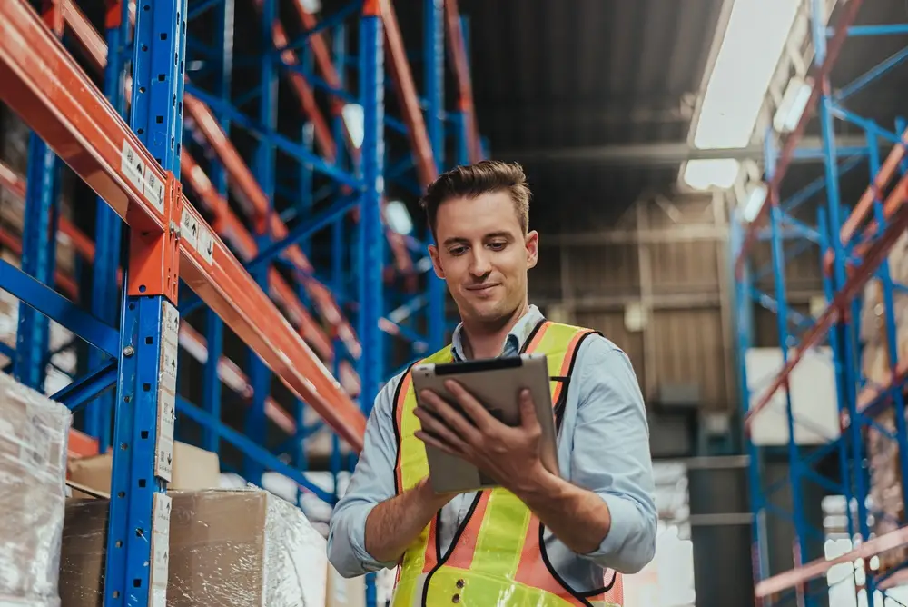 warehouse worker using erp software tablet