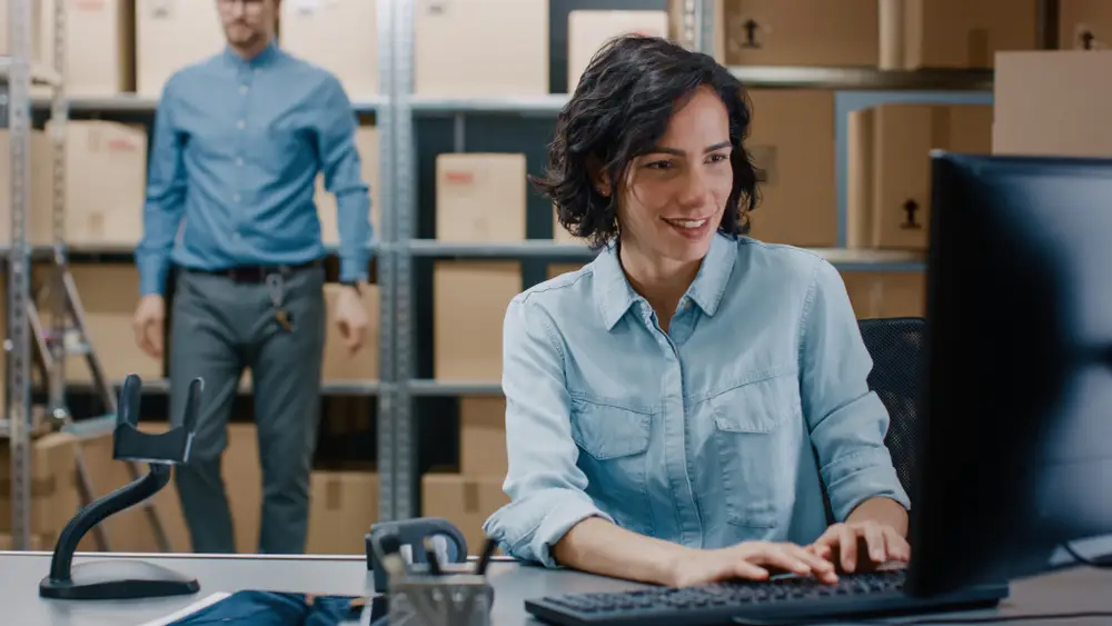 female warehouse manager using erp system computer