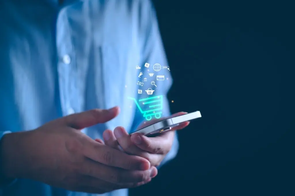 man holding smartphone with e-commerce illustration