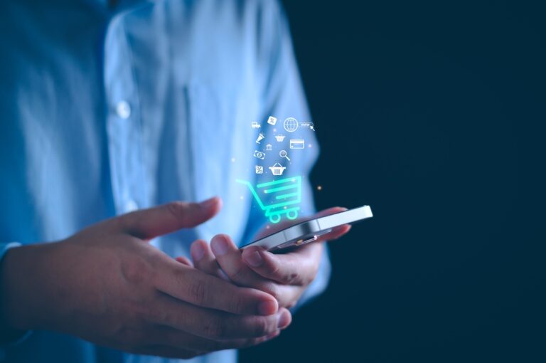 man holding smartphone with e-commerce illustration