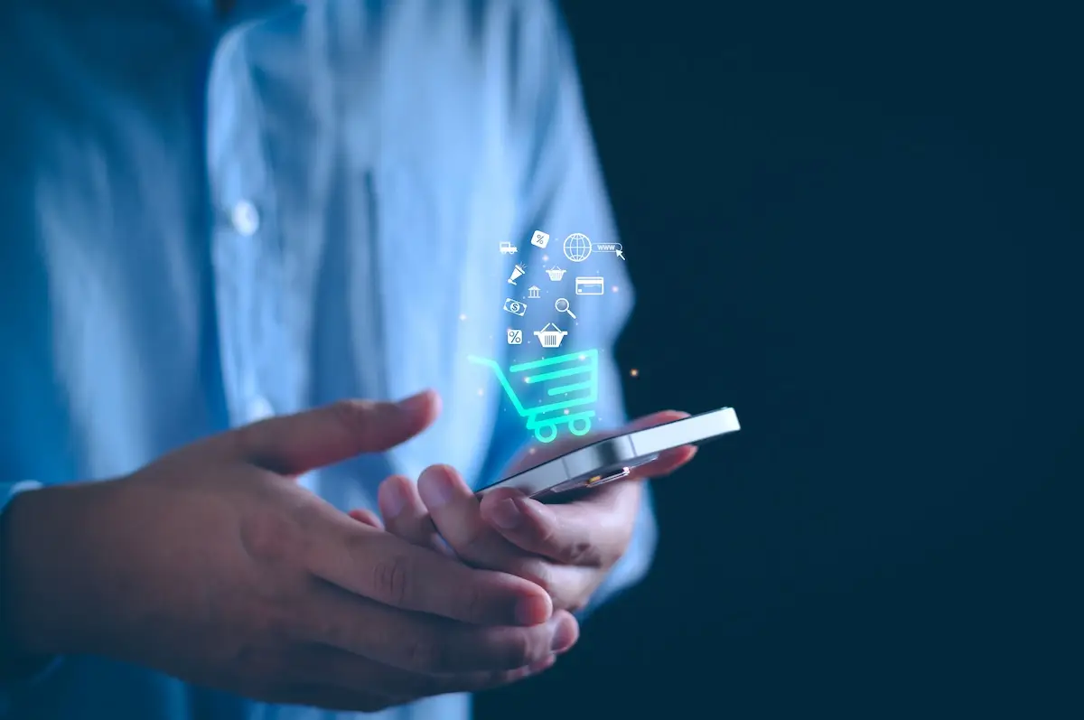 man holding smartphone with e-commerce illustration
