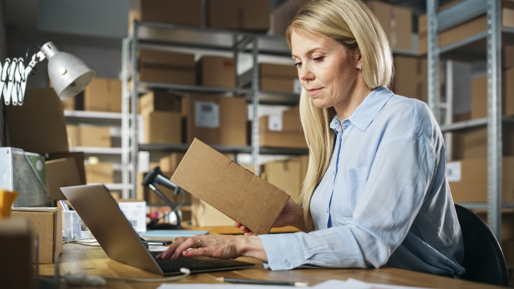 female distribution manager processing warehouse returns