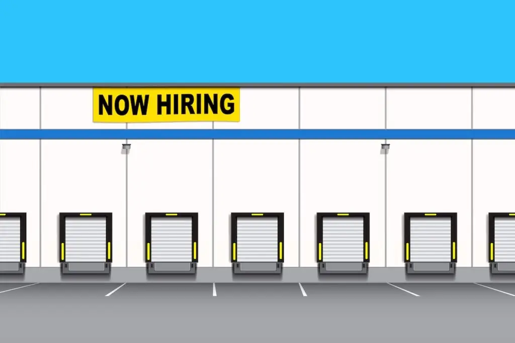 distribution warehouse with now hiring sign