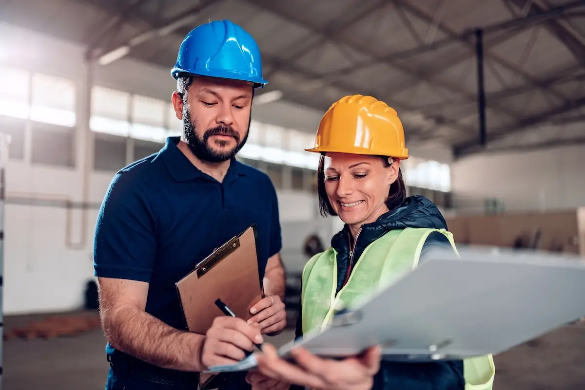 warehouse manager and worker signing a training document